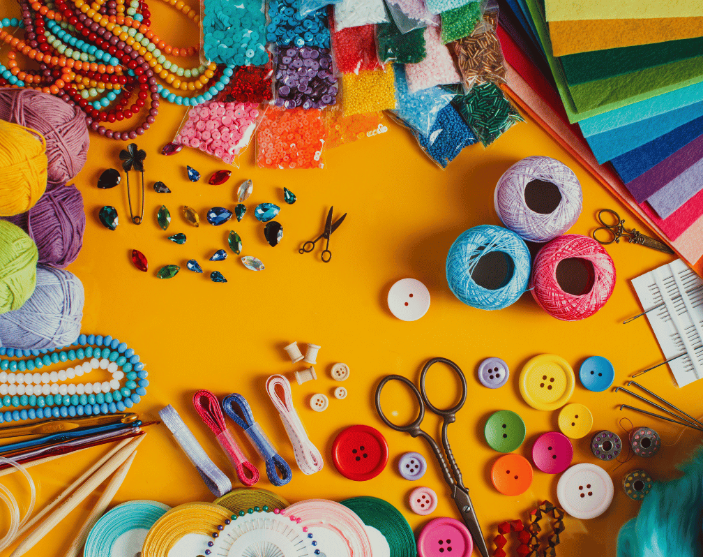 Image of all sorts of crafting material like yarn, buttons, paper, string, pens and lots more.