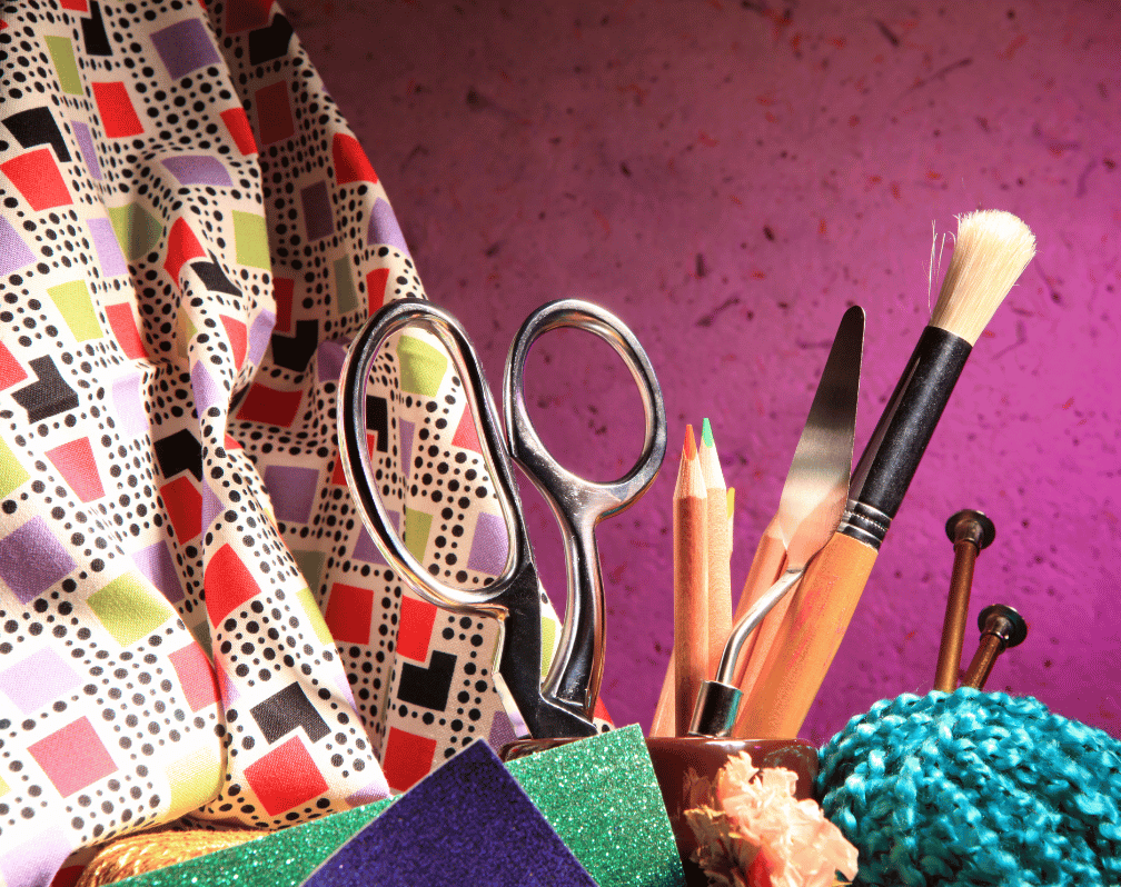 photo of various craft and art supplies against a purple background
